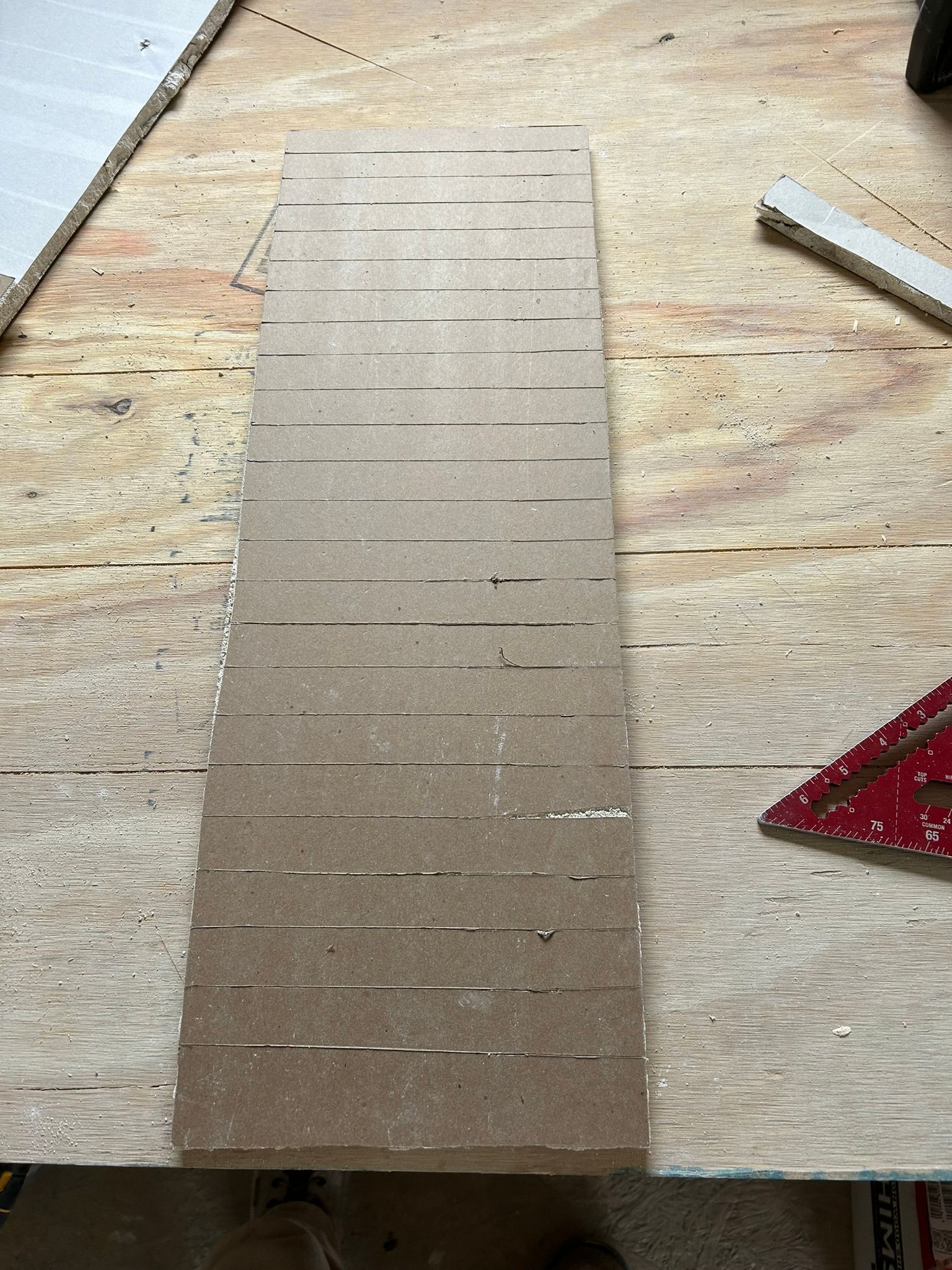 A piece of wood with lines on it is sitting on a wooden table.