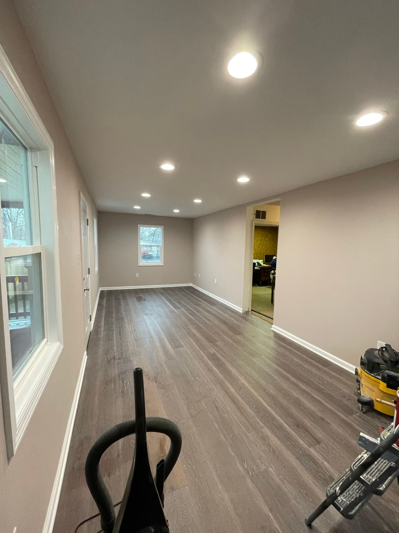 There is a vacuum cleaner in the middle of the room.