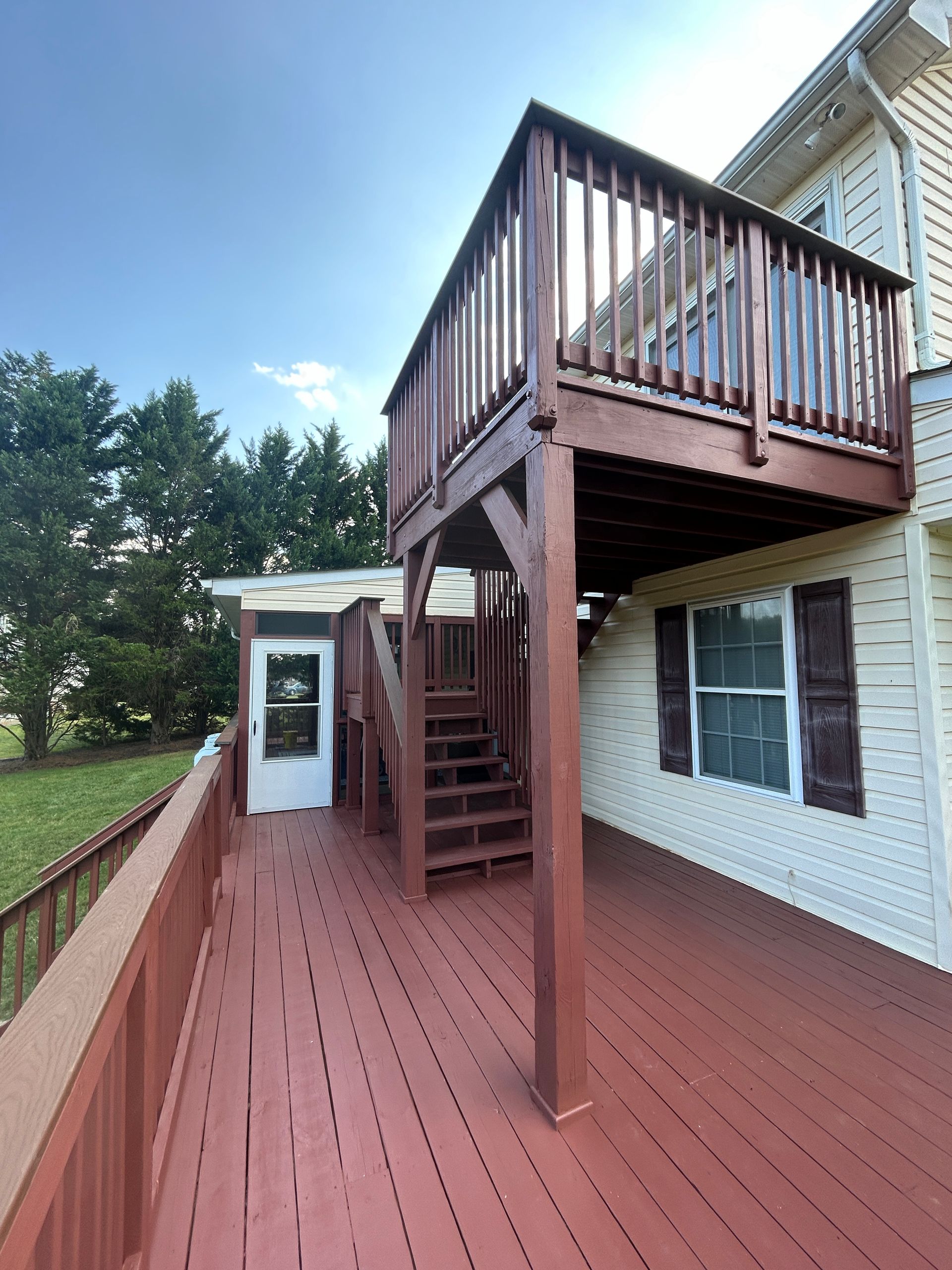A wooden deck with stairs leading up to it
