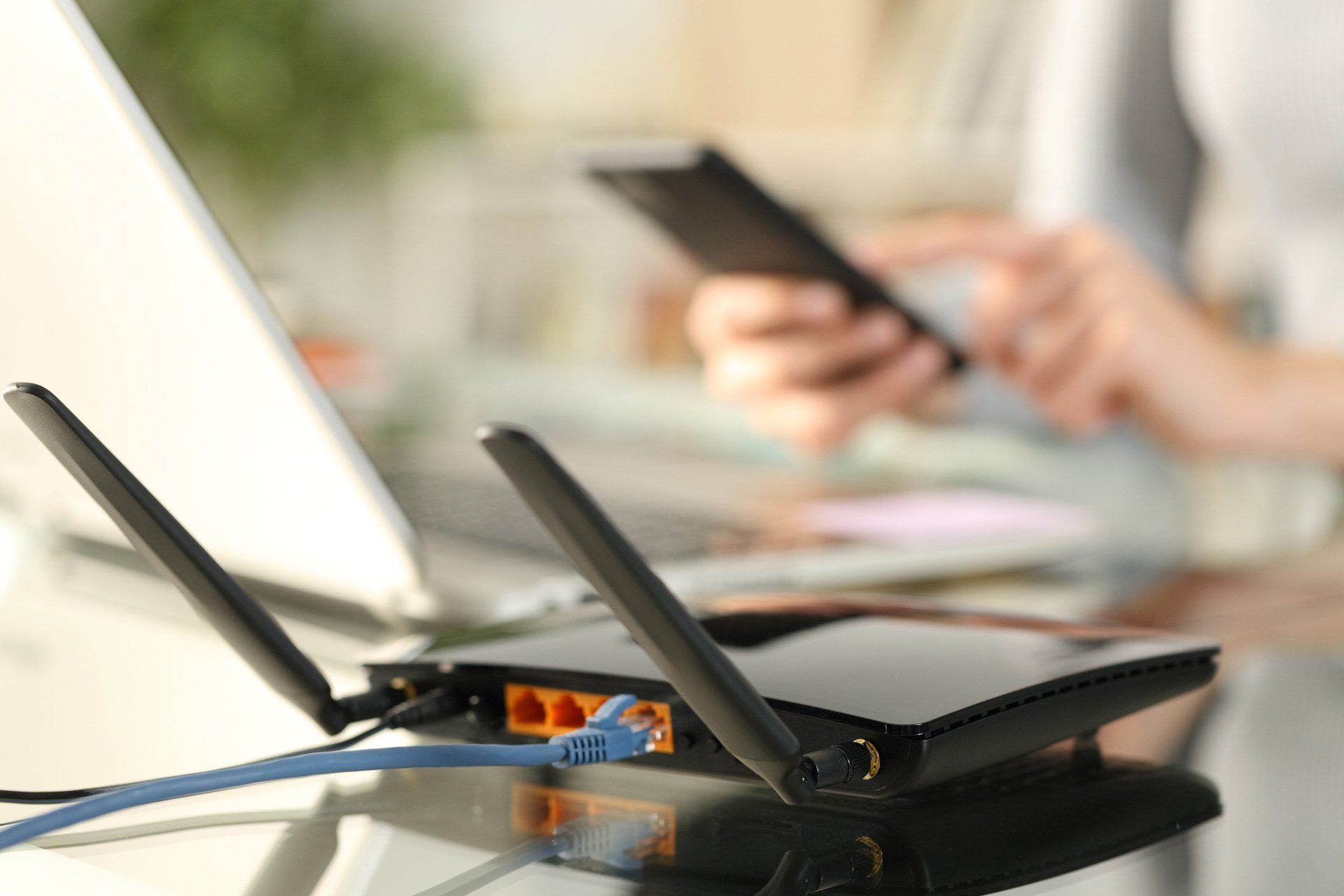 Woman Using Multiple Devices with Broadband Router on Foreground — Greater Sydney, Nsw — Connex Antenna & Security