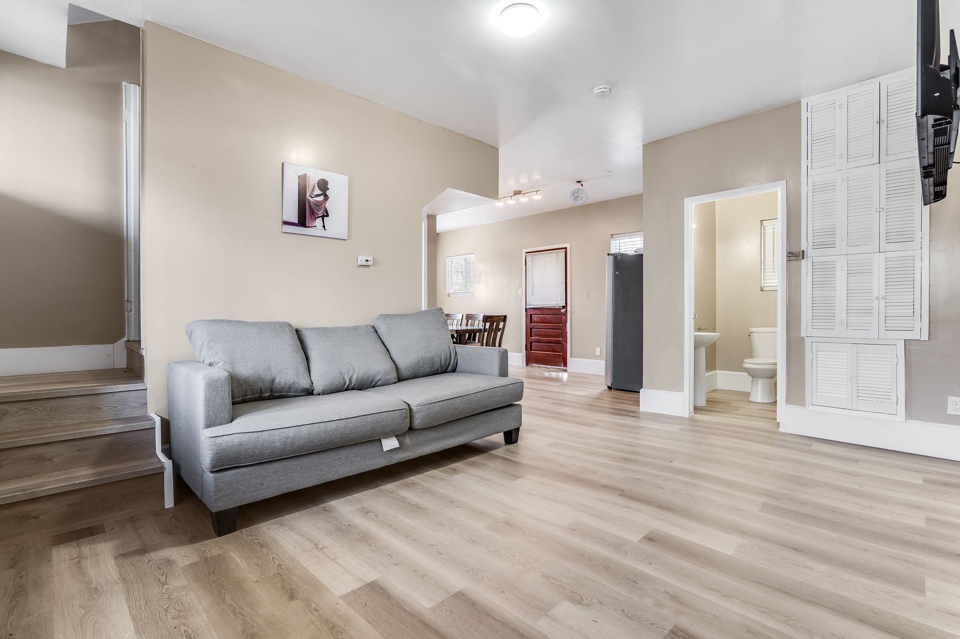 A living room with a couch and a flat screen tv.