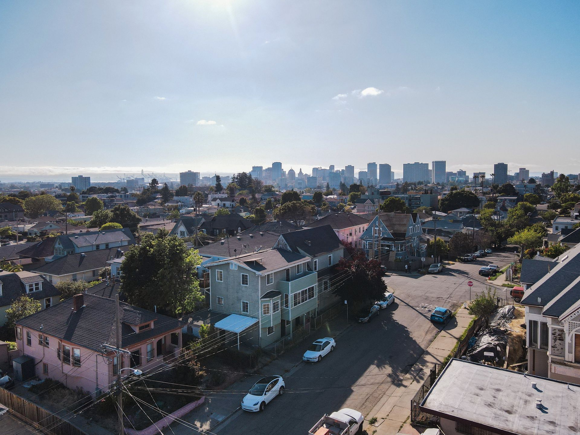 An aerial view of a residential area with a city in the background.