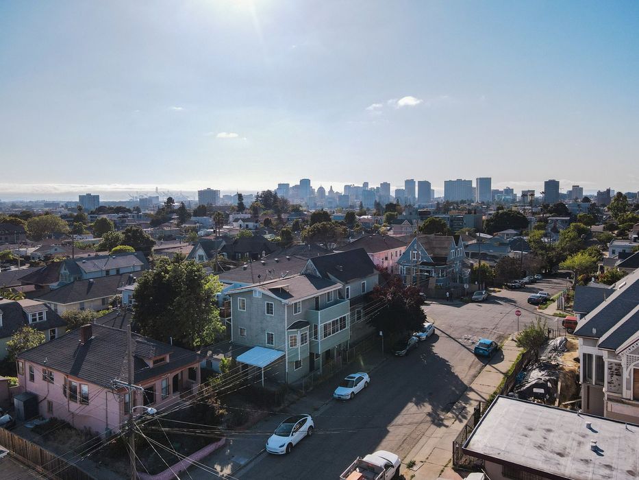 An aerial view of a residential area with a city in the background.