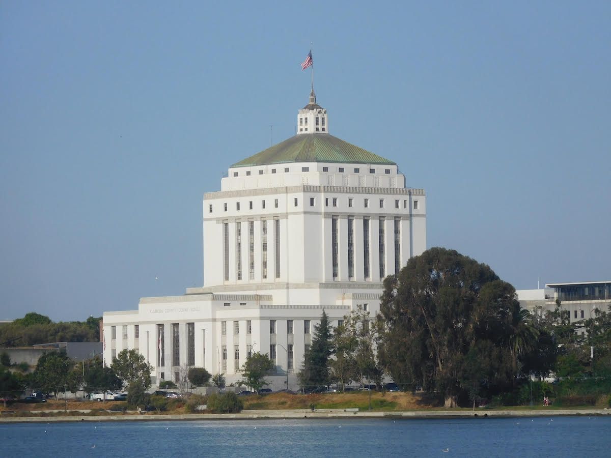 A large white building with a dome and a flag on top