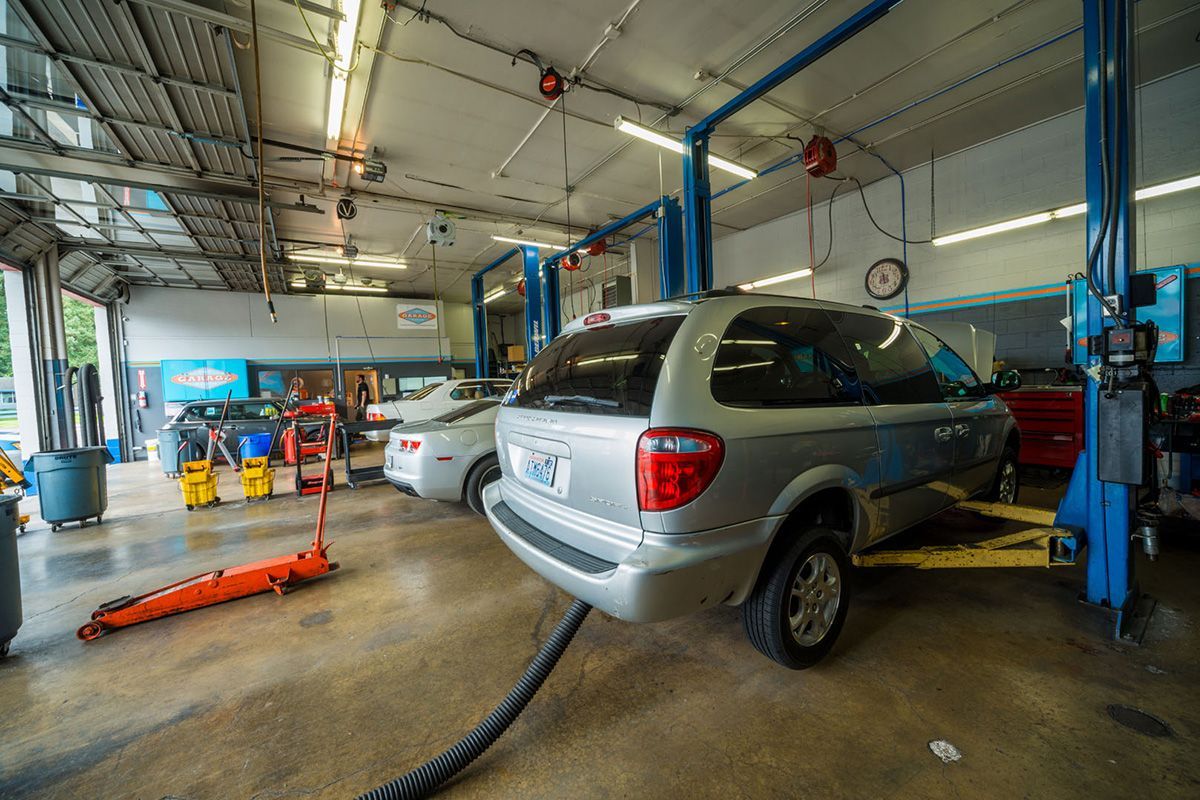 A van is sitting on a lift in a garage. | The Garage in Renton