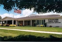 Funeral home building with an American flag and sign reading 
