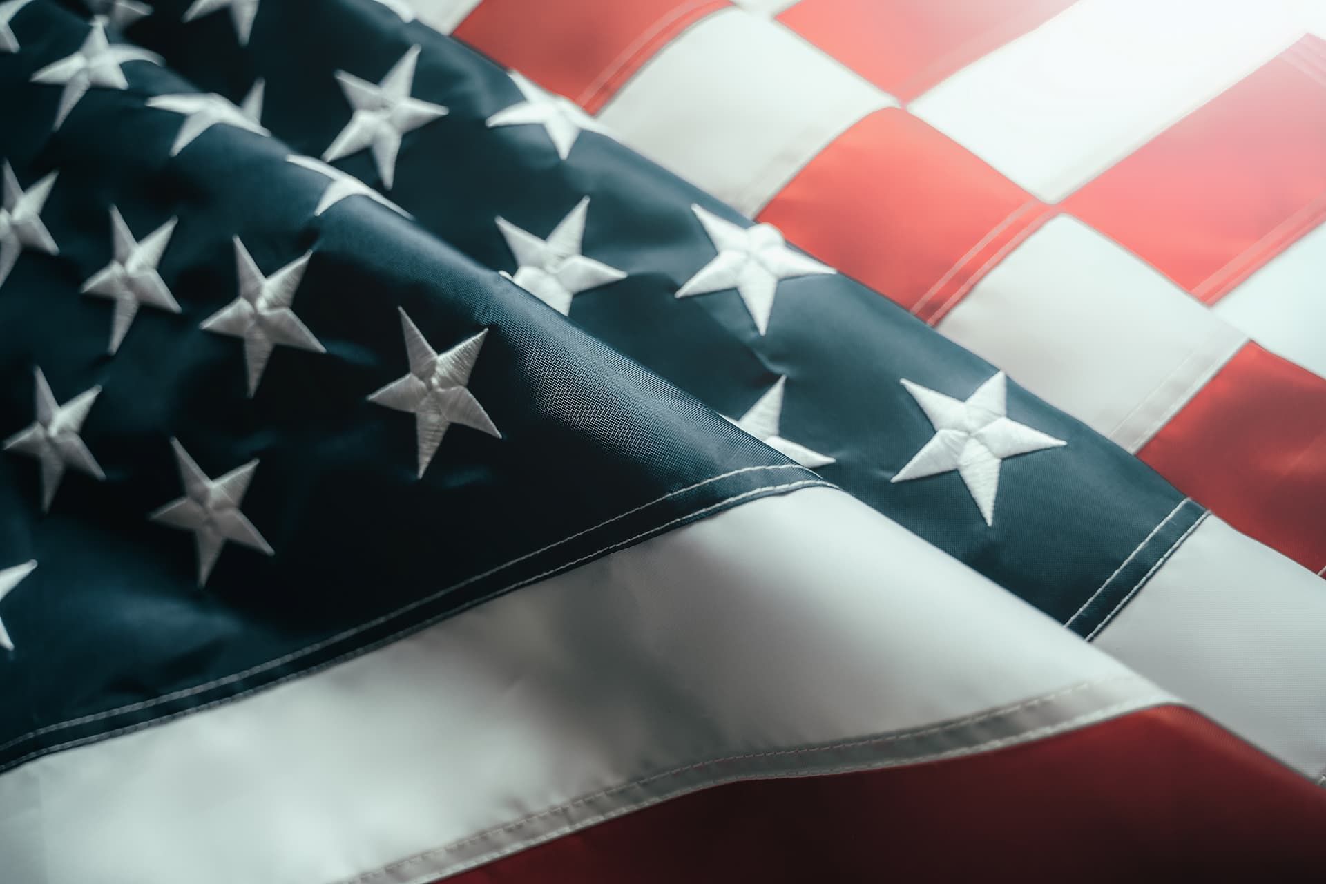 Close-up of a waving American flag with red, white, and blue stars and stripes