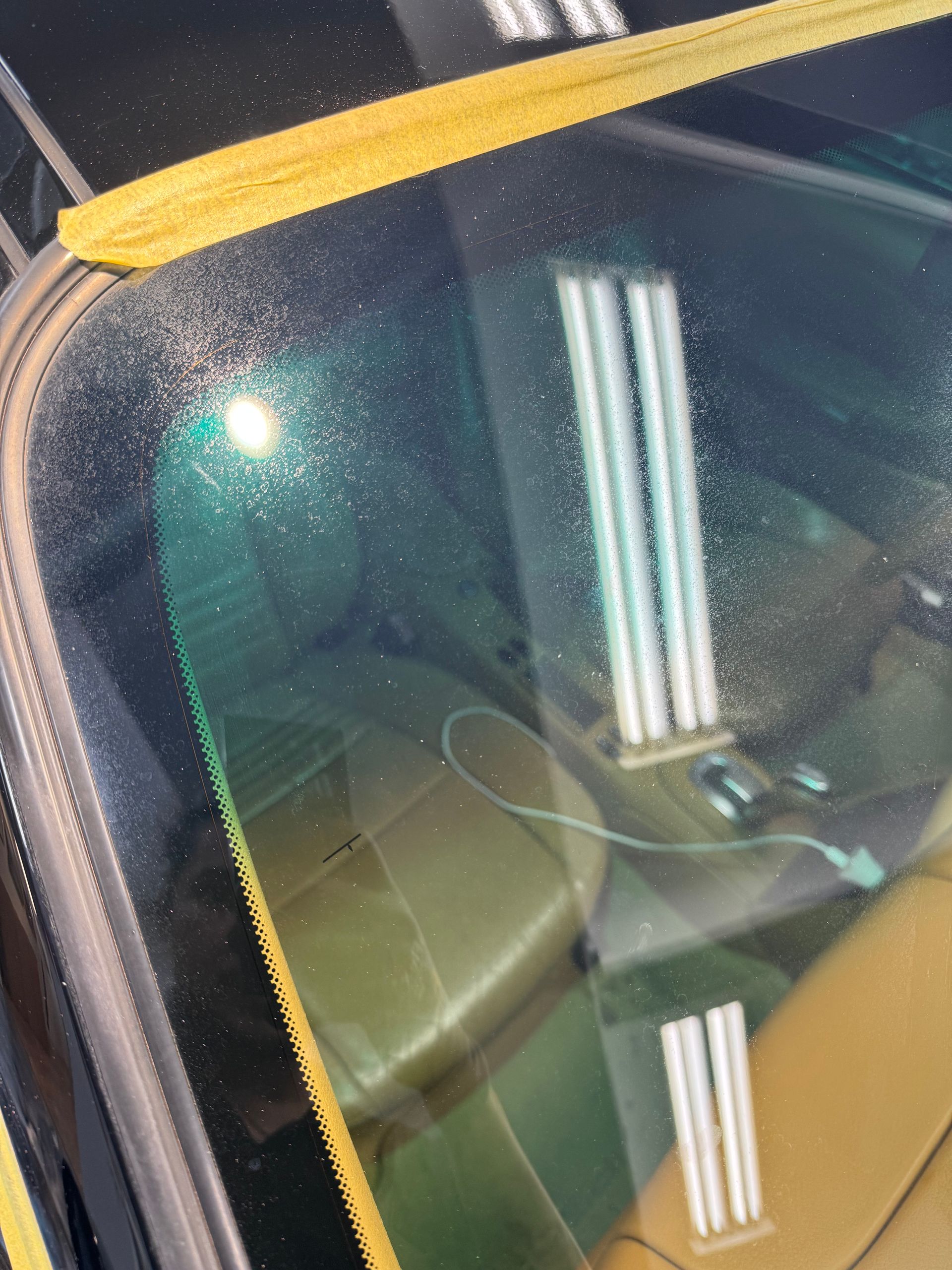 Porsche glass before — hard water etching and contamination