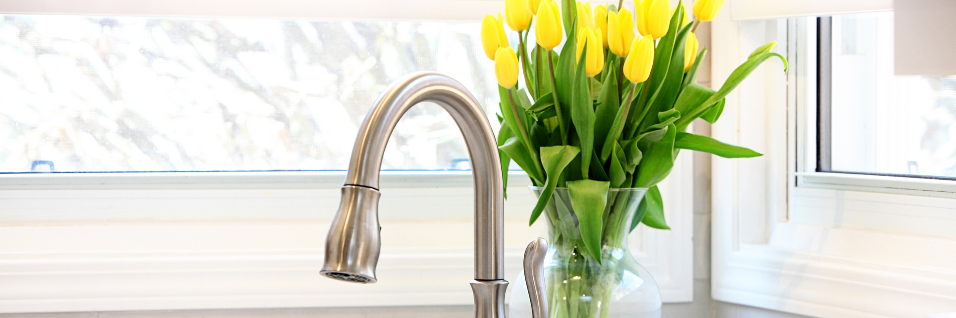 Faucet with flowers by the window