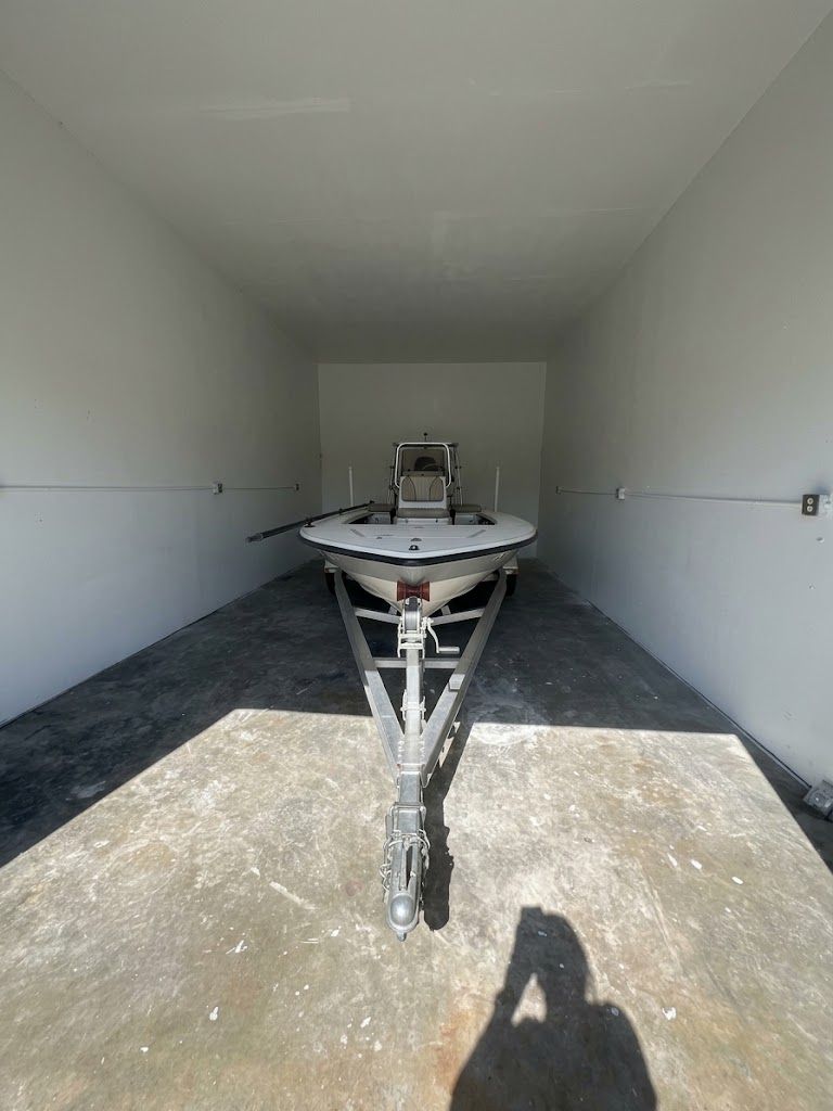 Boat on a trailer stored inside an enclosed large unit