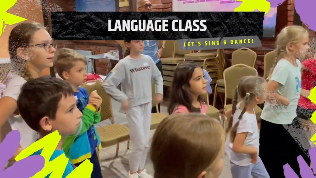 A group of children are dancing in a language class.
