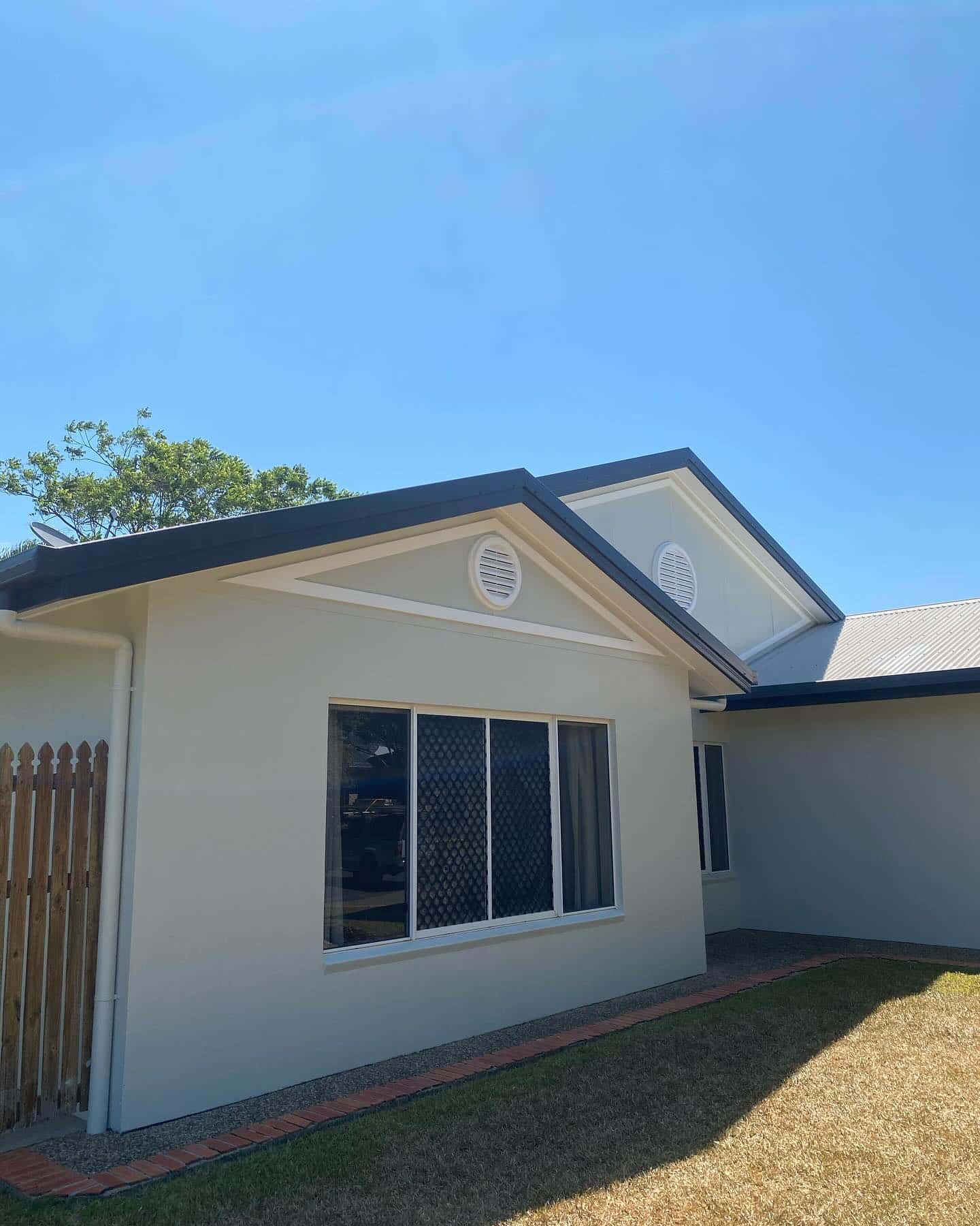 A White House With a Black Roof and a Lot of Windows — Supremacy Painting Co In White Rock, QLD