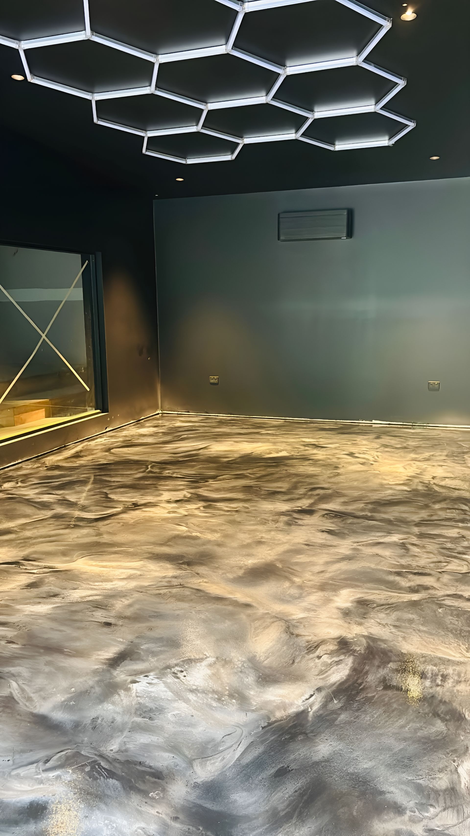 A Person Pours Liquid Grey Self-leveling — Supremacy Painting Co In Palm Cove, QLD