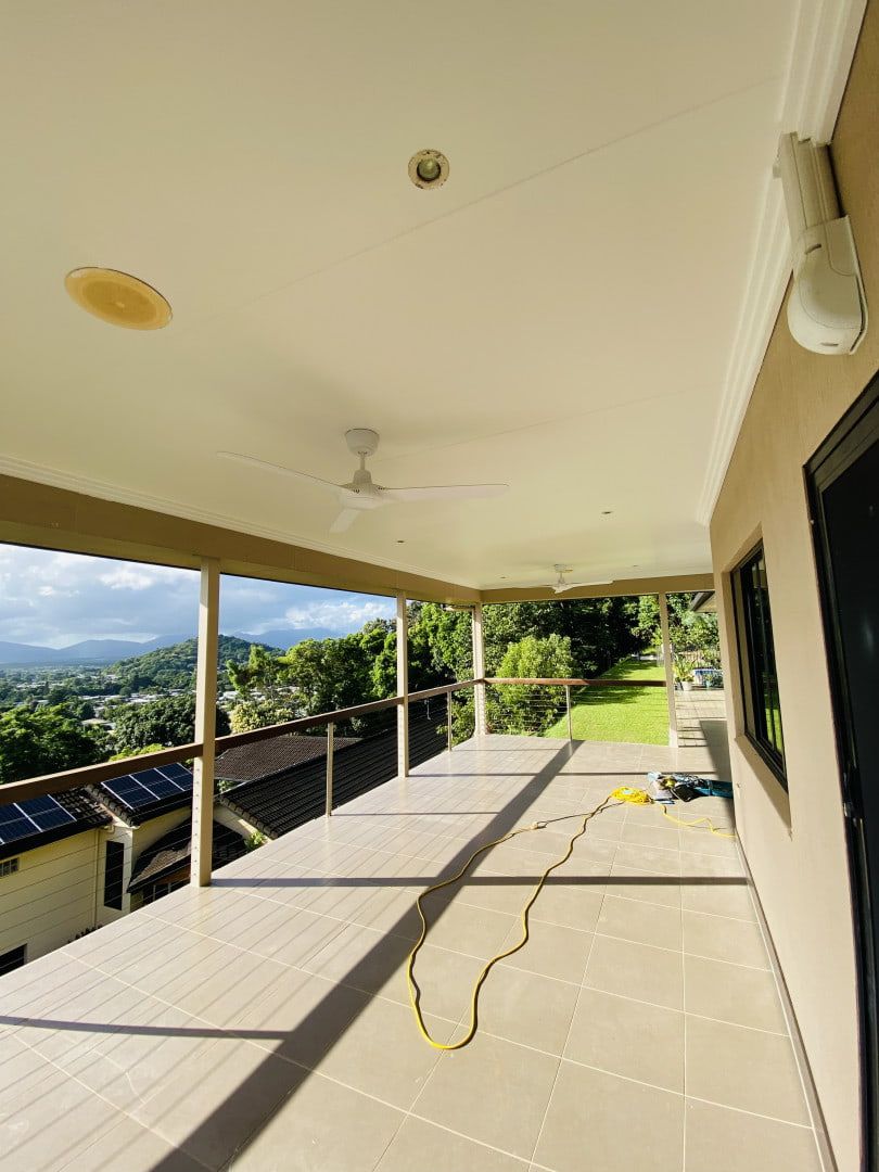 A Large Porch With a Ceiling Fan and a View of the Mountains — Supremacy Painting Co In White Rock, QLD