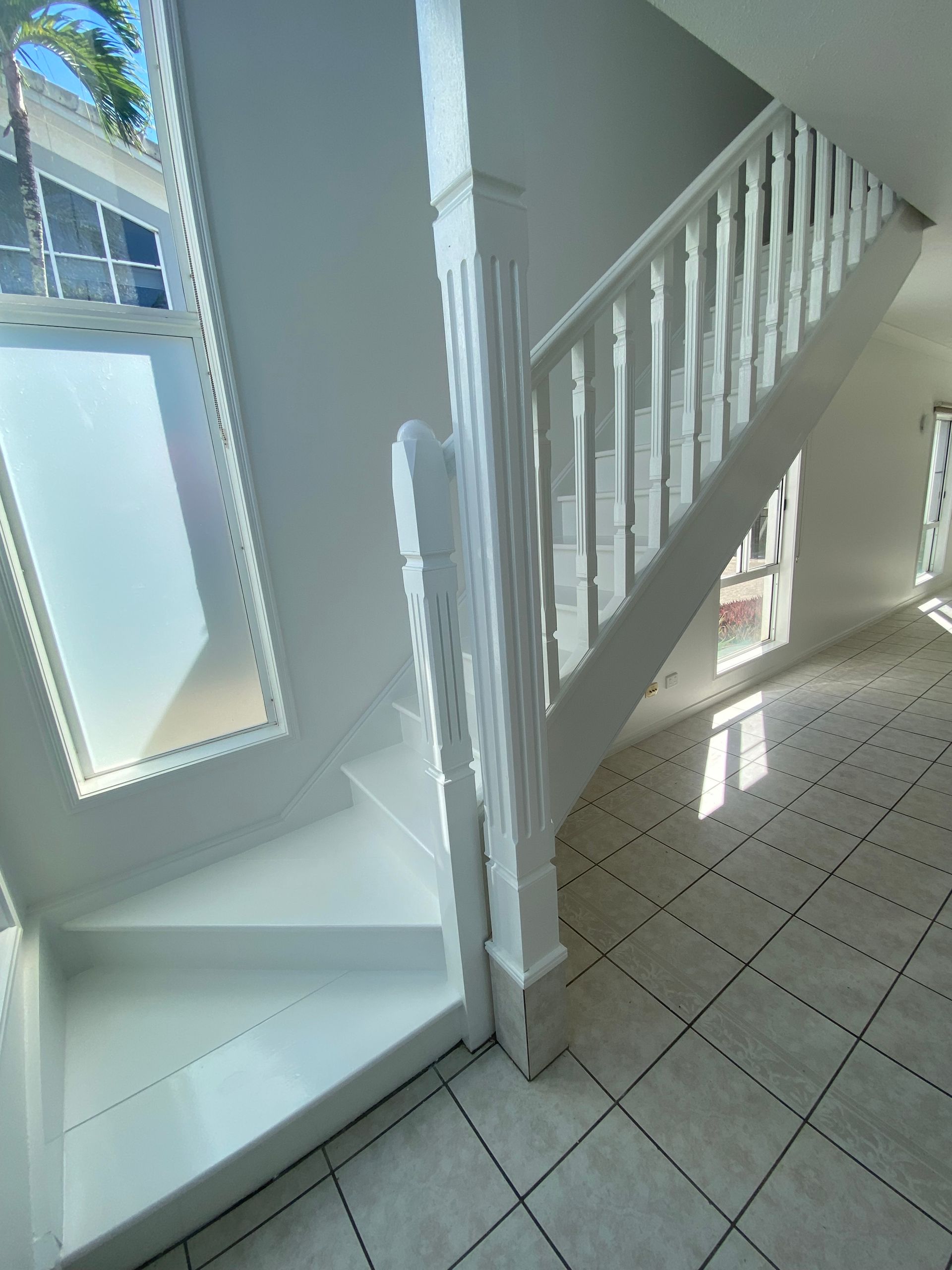 A Person in a Dark Shirt Using a Paint Roller — Supremacy Painting Co In Palm Cove, QLD