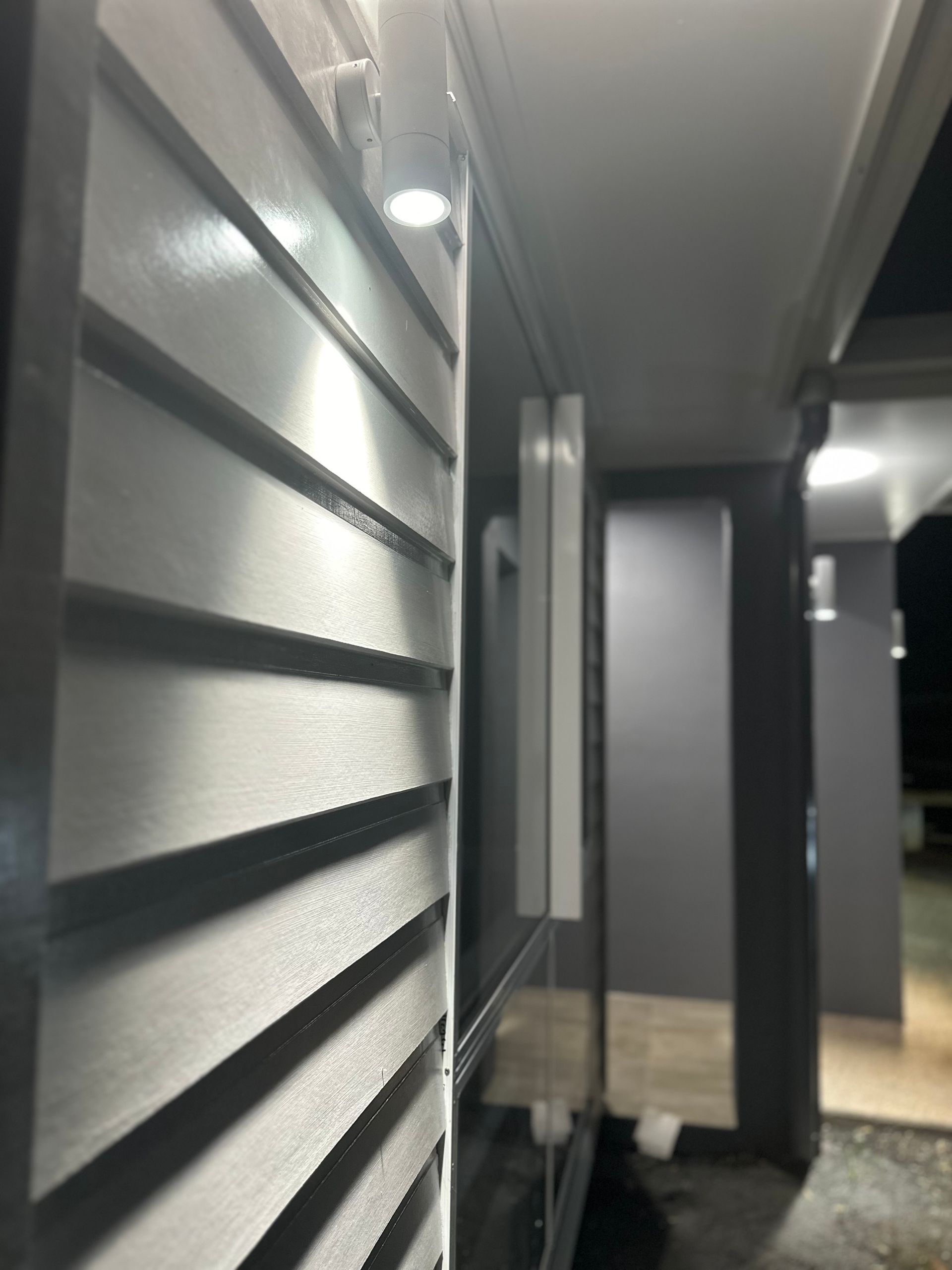 A Purple Paint Roller is Being Used to Paint a White Wall — Supremacy Painting Co In Edmonton, QLD