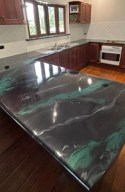 Kitchen with a glossy black-and-green marble island, dark wood cabinets, and a window above the sink. — Supremacy Painting Co In White Rock, QLD