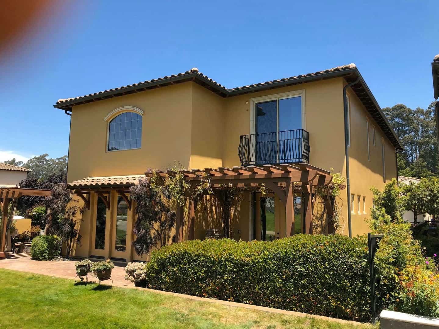 A dining room with a table and chairs and stairs leading up to the second floor.