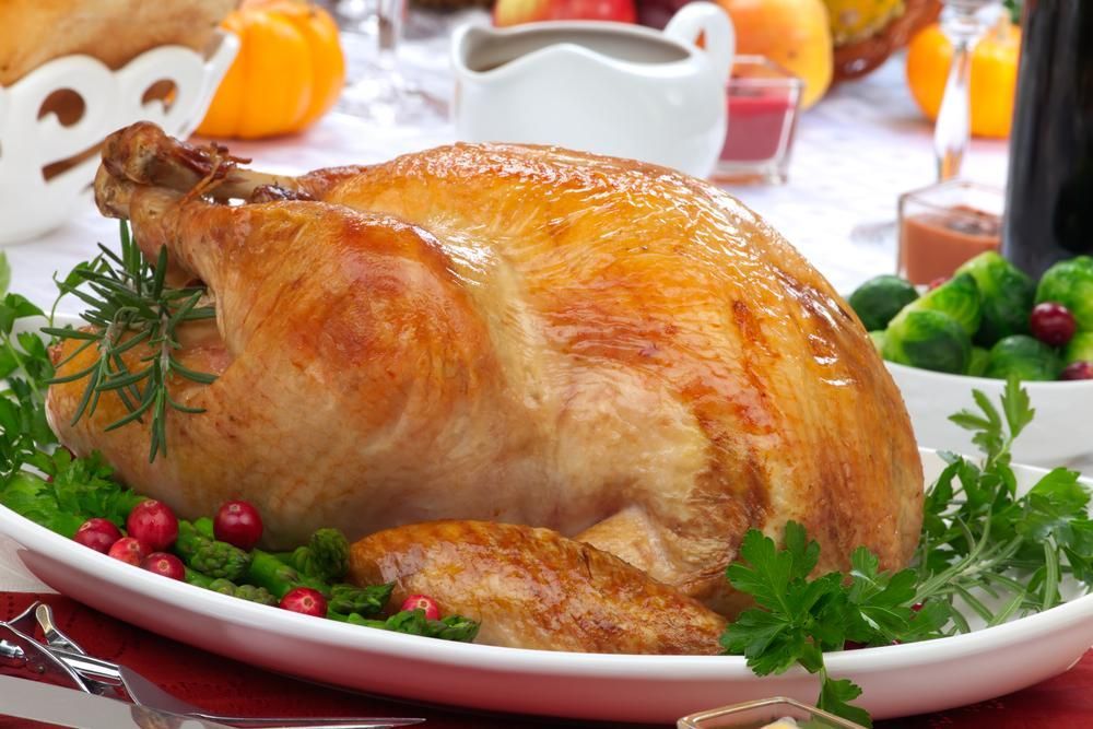 A Roasted Turkey on A White Plate with Cranberries and Parsley — Gungahlin Kebab and Pizza in Gungahlin, ACT