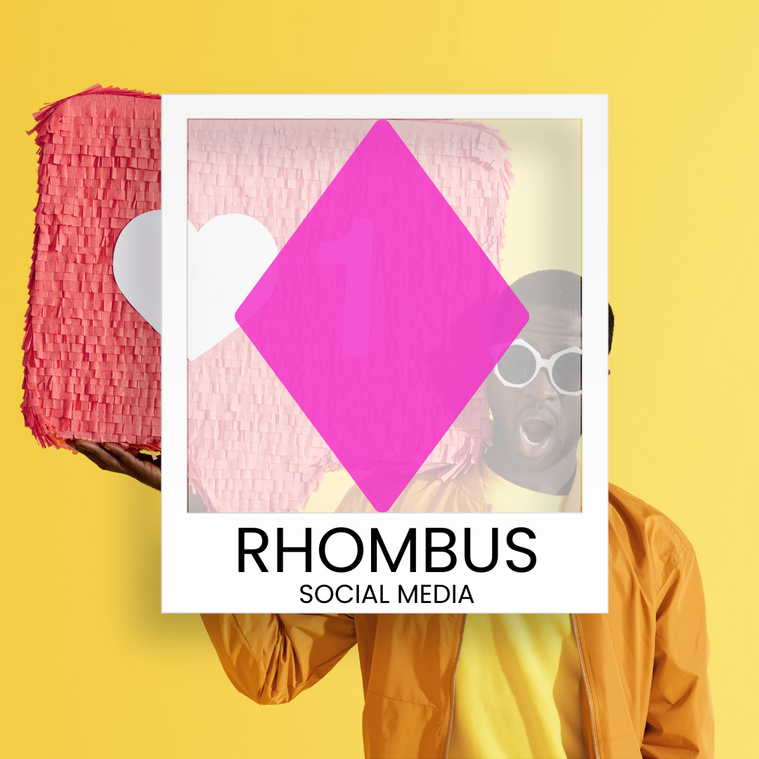 A man is holding a picture of a pink diamond in front of his face.