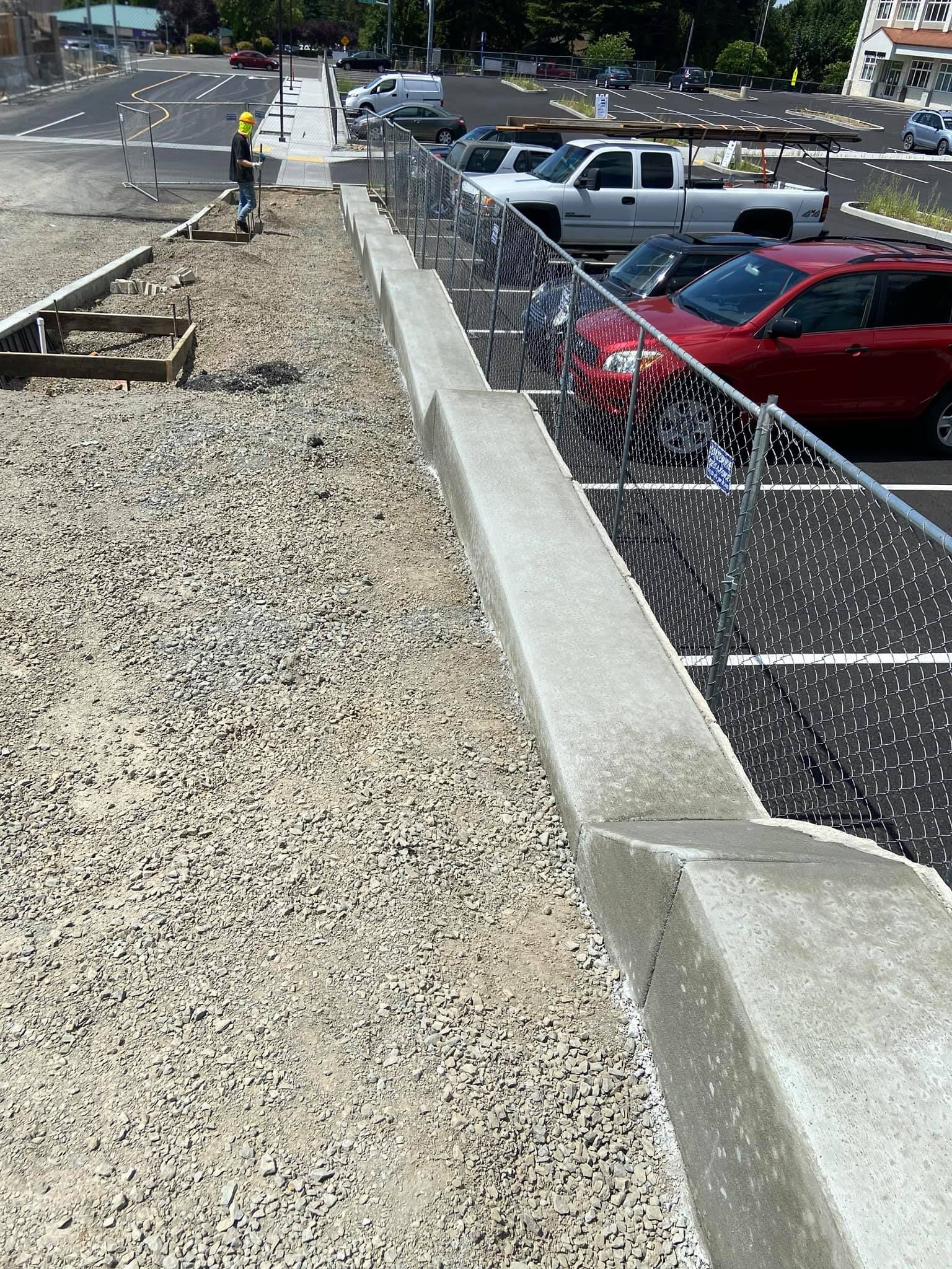 a concrete walkway is being built in a parking lot in Vancouver, WA by NAVA Concrete LLC