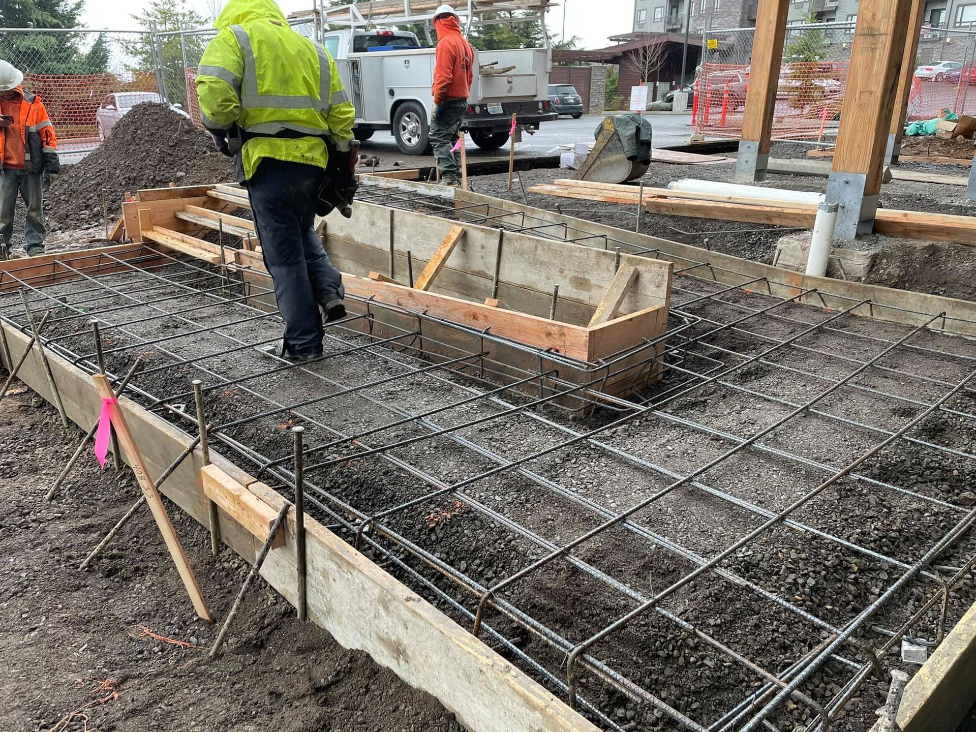 A group of construction workers are working on a construction site in Vancouver, WA by NAVA Concrete LLC