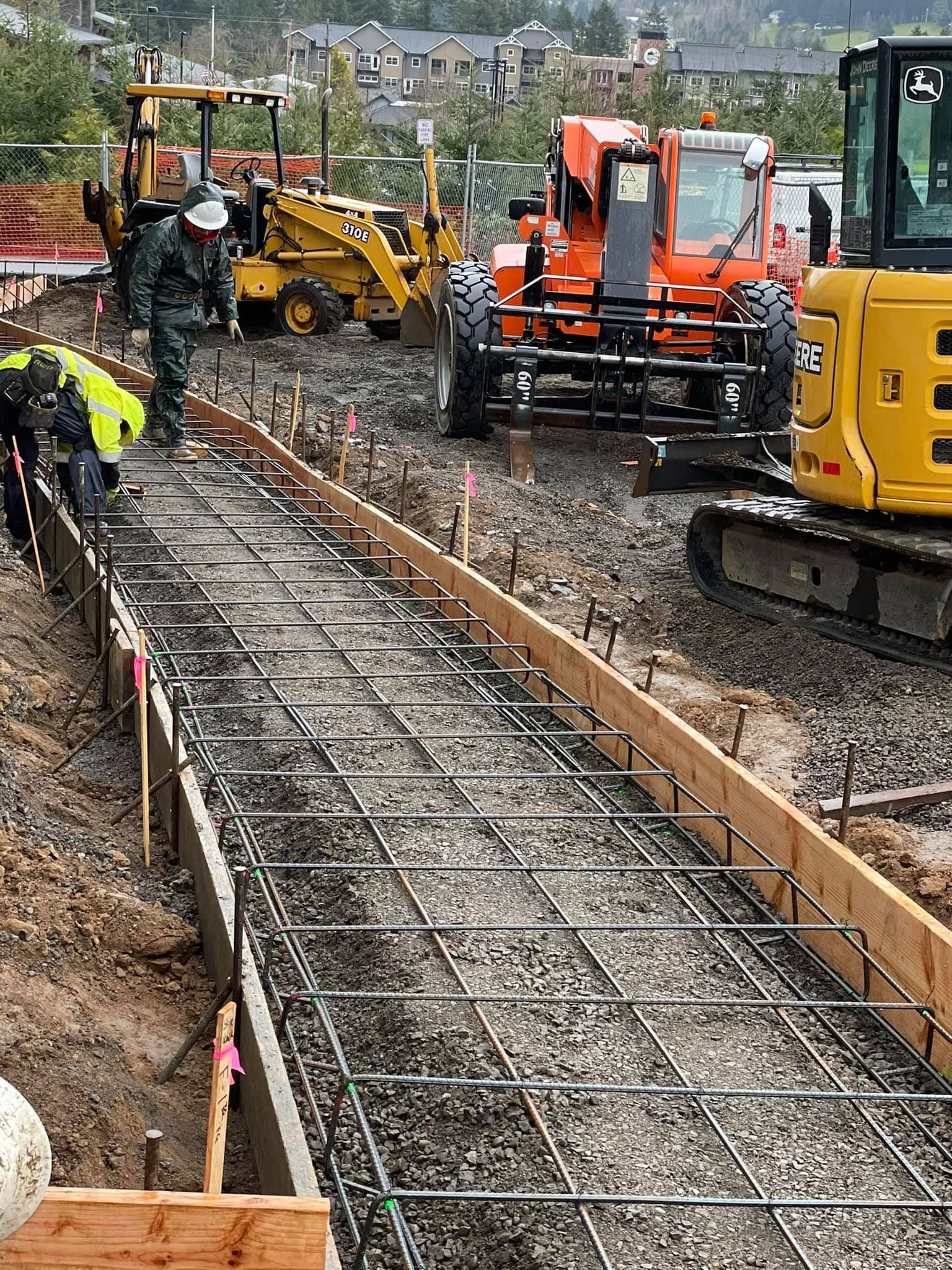 A group of construction workers are working on a road in Vancouver, WA by NAVA Concrete LLC