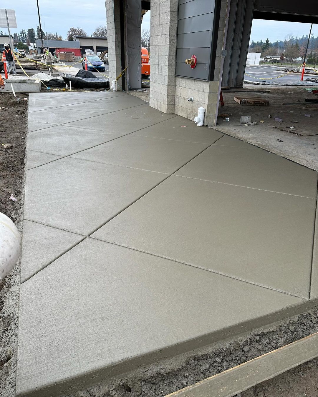 A concrete walkway is being built in front of a building in Vancouver, WA by NAVA Concrete LLC