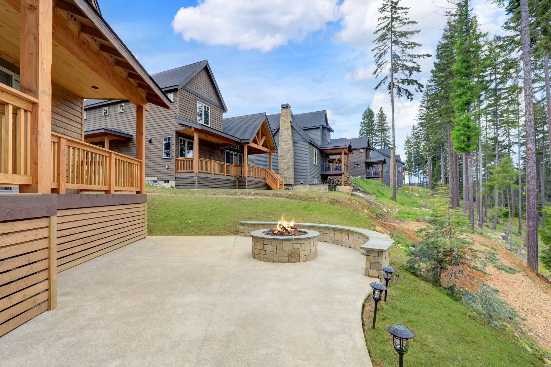A large house with a fire pit in front of it in Vancouver, WA by NAVA Concrete LLC