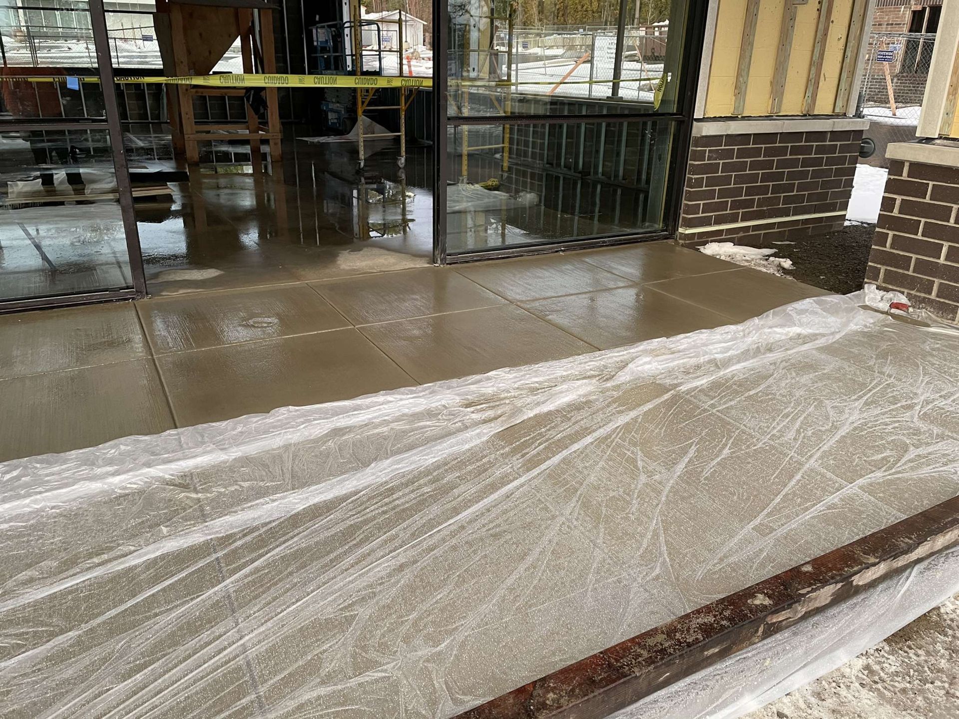 A concrete walkway is being installed in front of a building under construction in Vancouver, WA