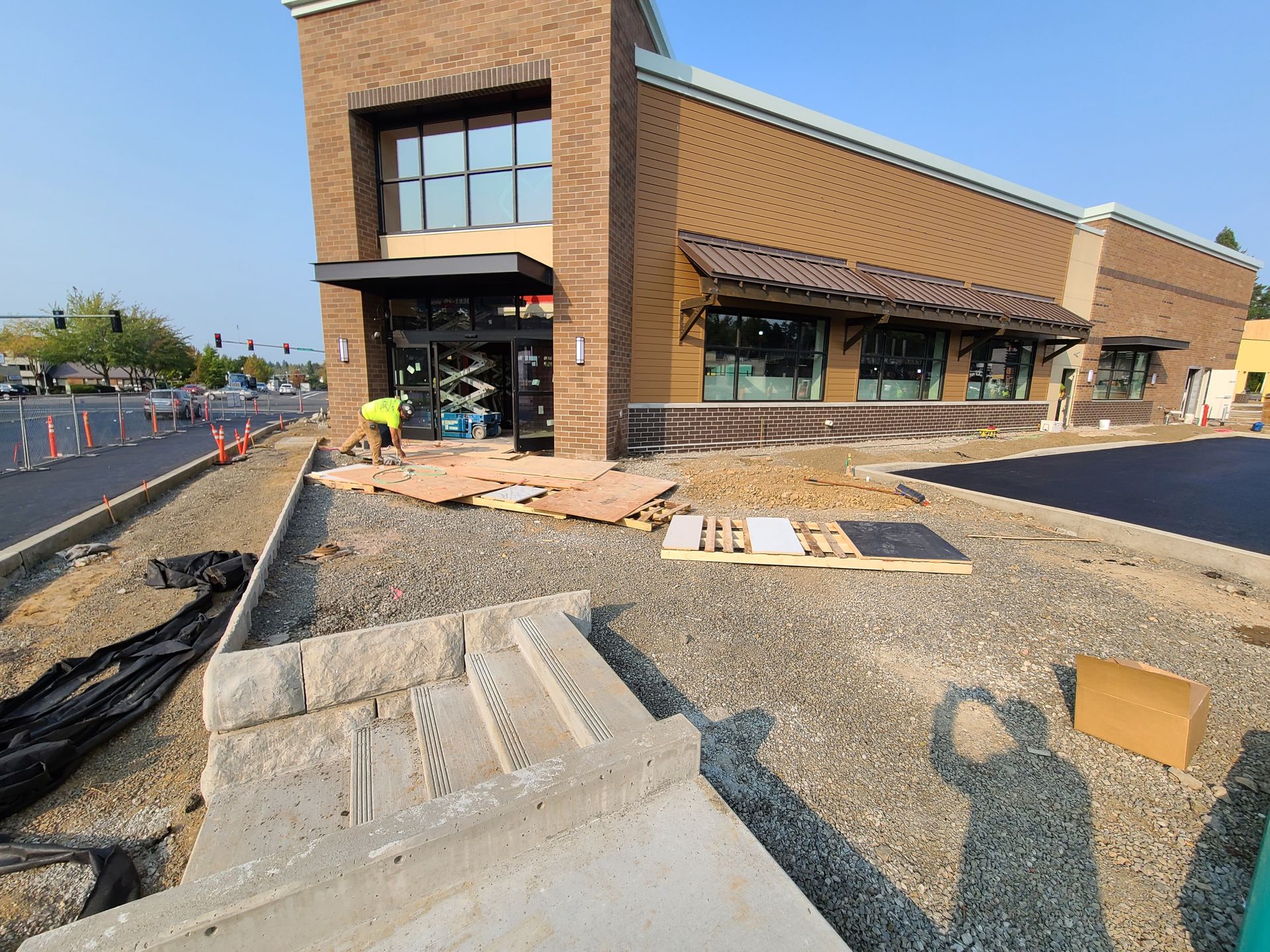 A large brick building is being built next to a gravel road in Vancouver, WA by NAVA Concrete LLC