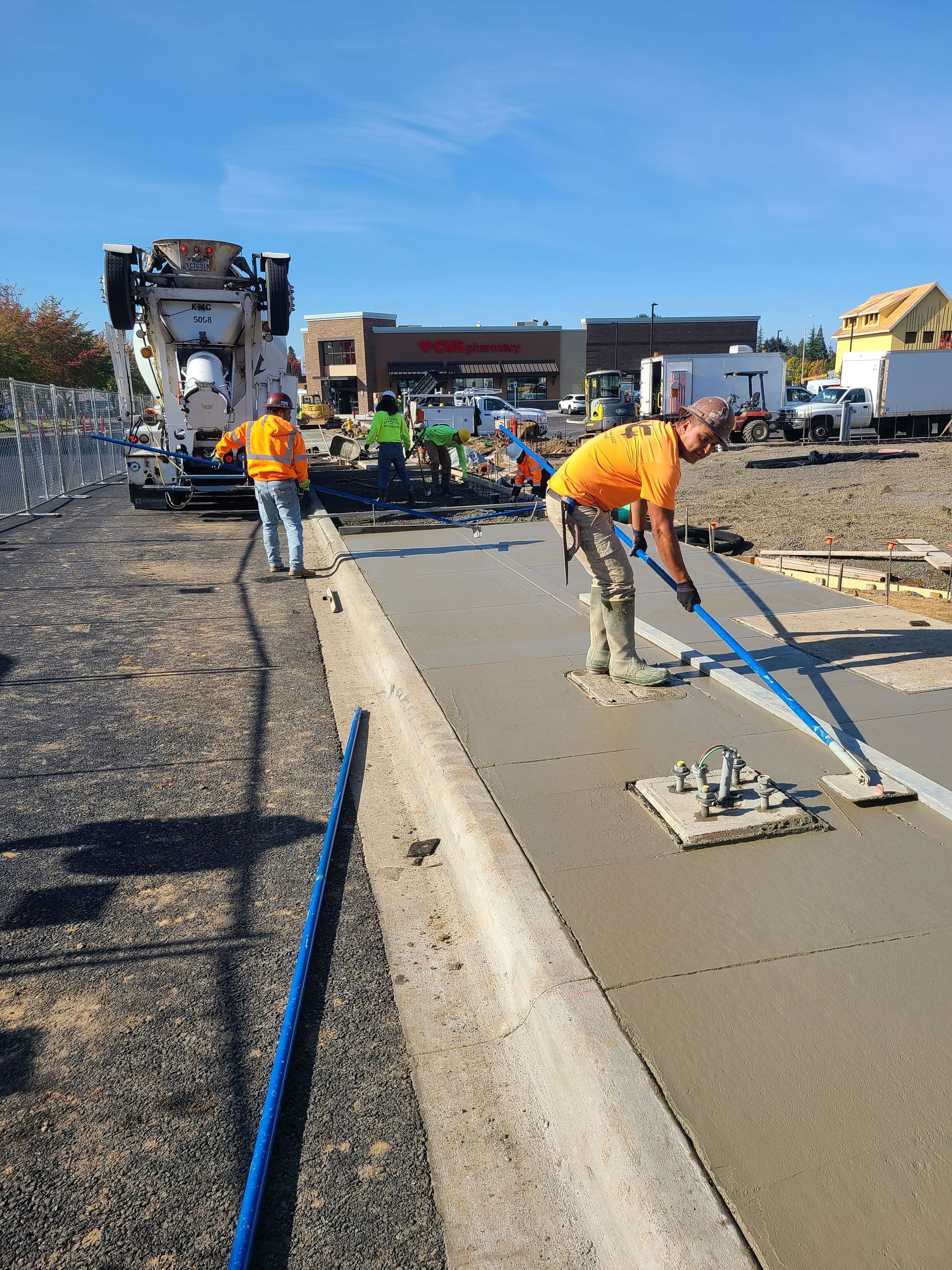 A group of construction workers are working on a sidewalk in Vancouver, WA by NAVA Concrete LLC