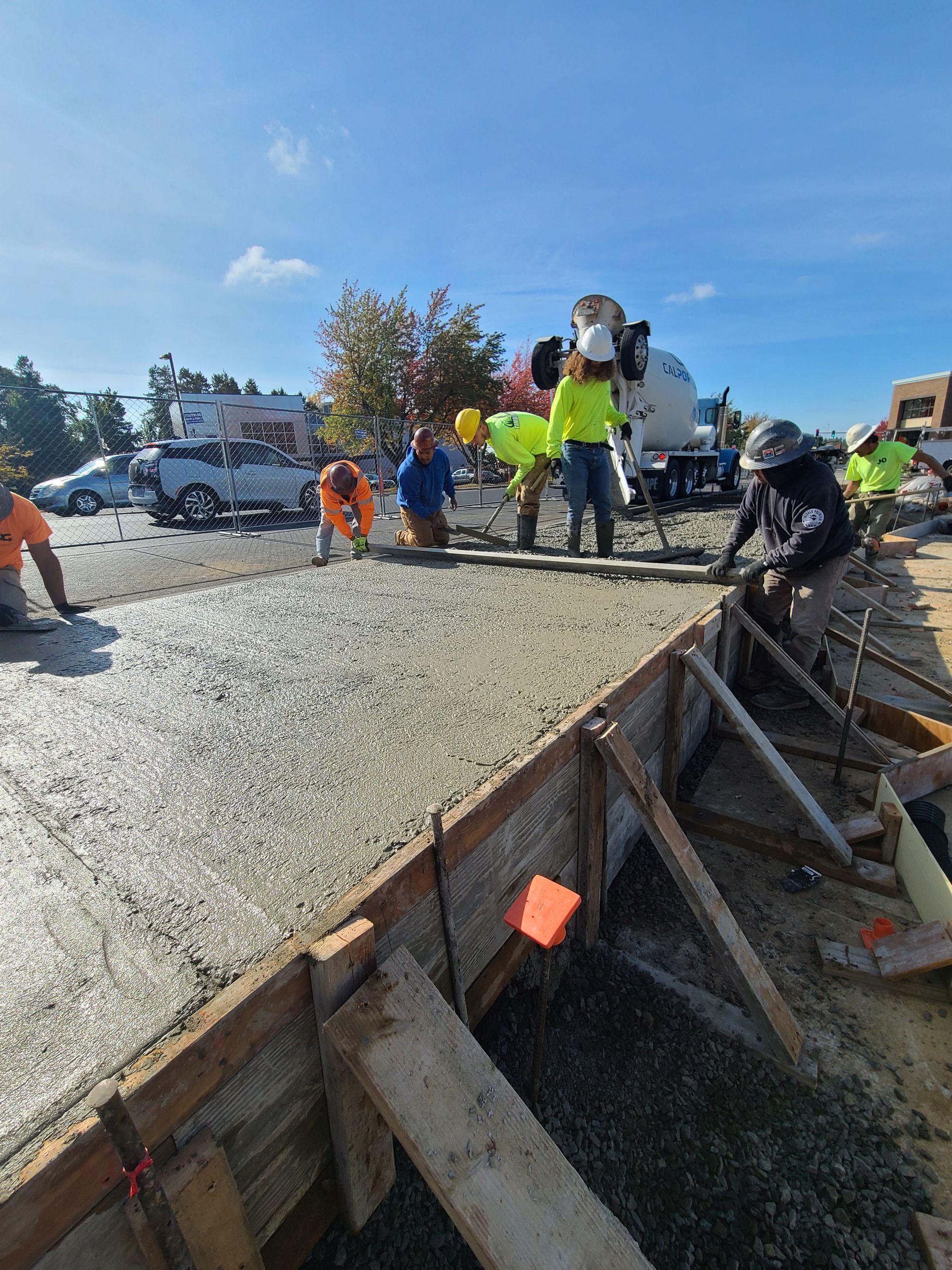 A group of construction workers are working on a concrete driveway in Vancouver, WA by NAVA Concrete LLC
