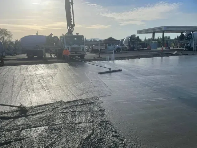 A concrete sidewalk bordered by green grass