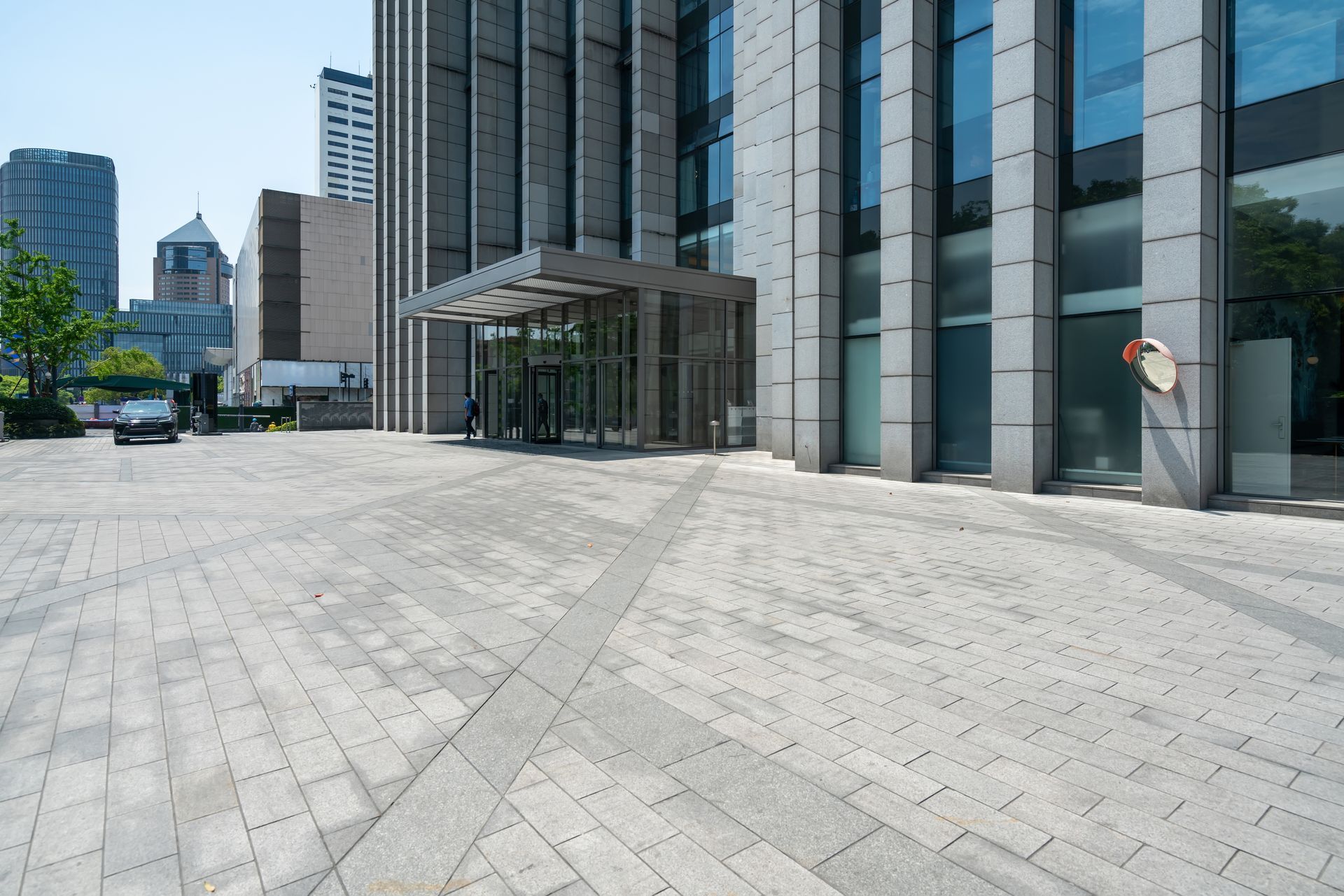 A large building with a brick walkway in front of it.