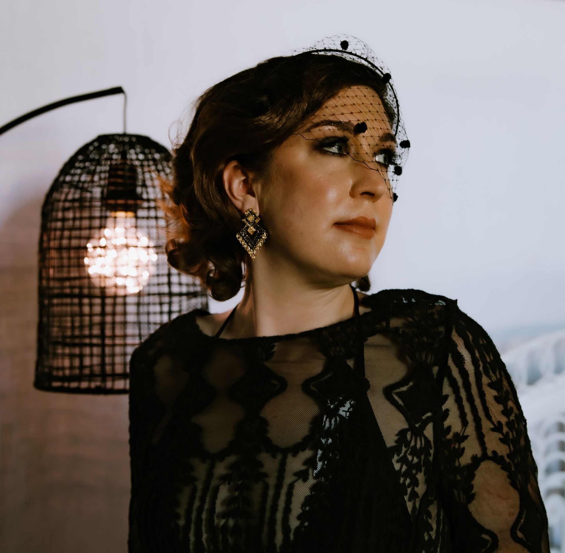 A woman in a black dress with a veil on her face — Lavie Hair & Beauty in Ciccone, NT