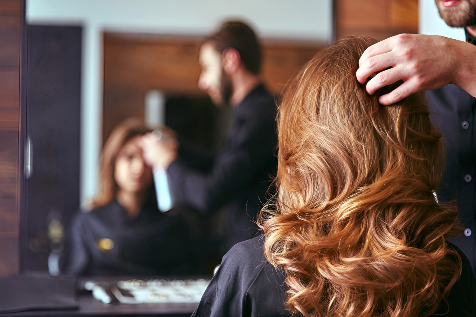 Woman is Getting Her Hair Cut by a Hairdresser — Lavie Hair & Beauty in Ciccone, NT