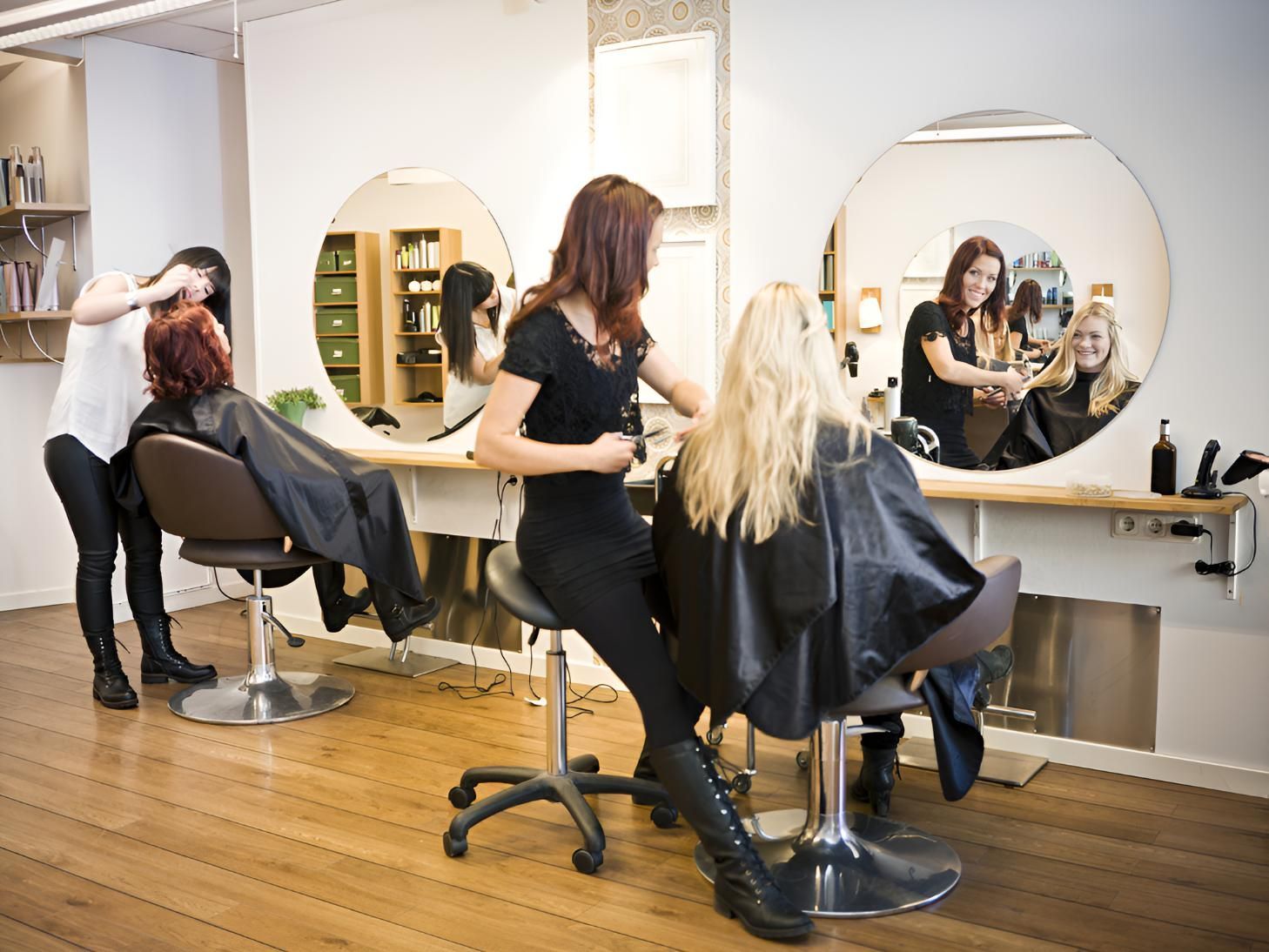 Woman is Getting Her Hair Cut by a Hairdresser — Lavie Hair & Beauty in Ciccone, NT