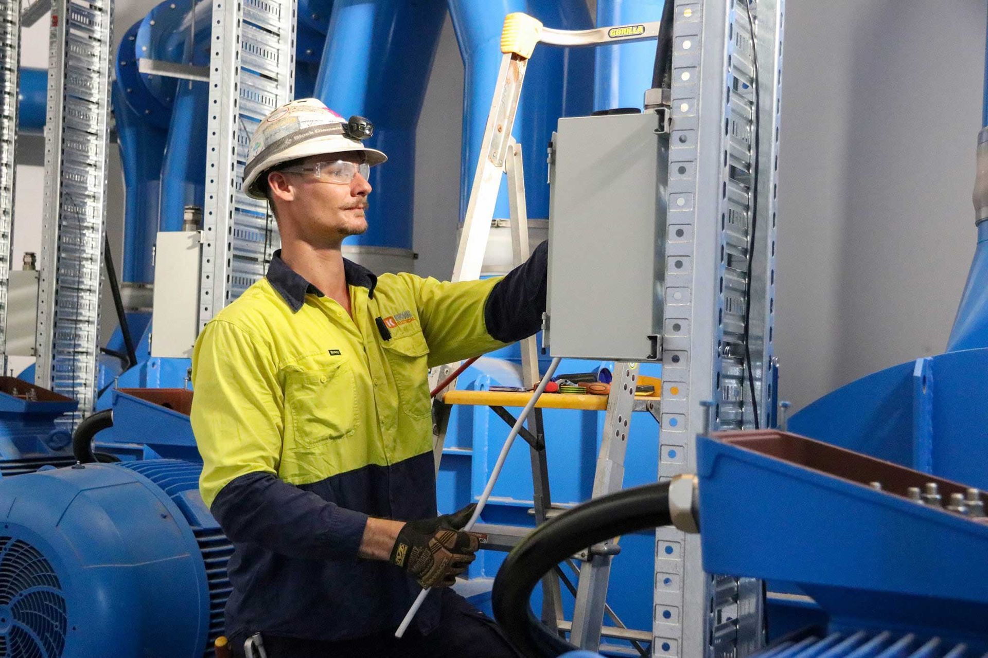 Electrician looking inside a circuit breaker box