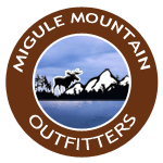 A logo for migule mountain outfitters with a moose and mountains in the background.