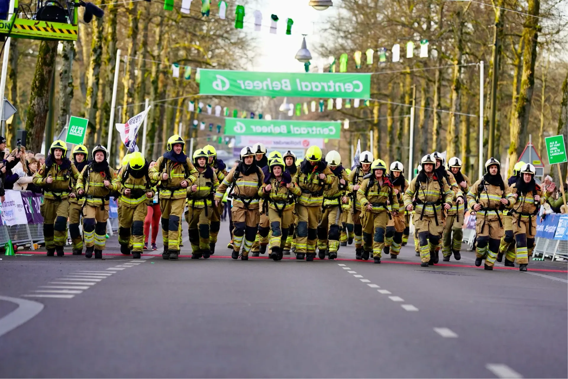 Brandweerteam loopt gezamenlijk richting finish tijdens de Midwinter Marathon Apeldoorn.
©2026-Strikwerda Fotografie