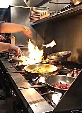 Chef preparing meals in the Sage Room kitchen.