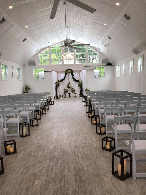 A large room with rows of chairs and lanterns
