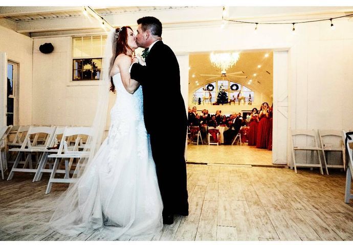 A bride and groom kissing at their wedding reception