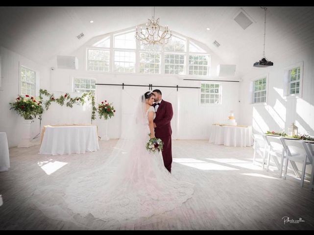 A bride and groom are posing for a picture in a white room.