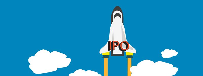 Rocket launching with “IPO” on its body against a bright blue sky with clouds