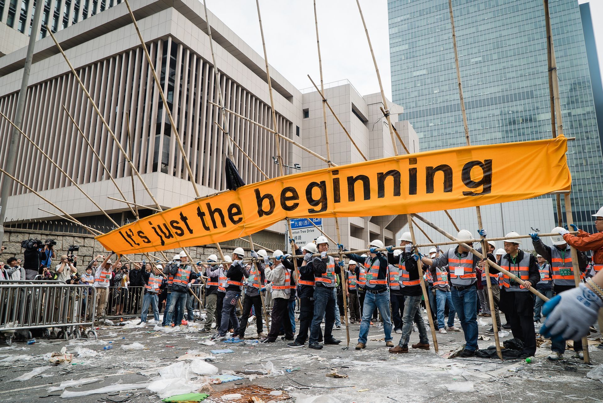 Group of people holding a banner saying