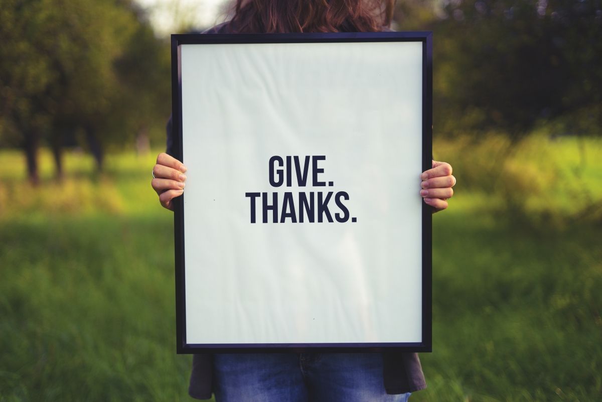 Person holding a sign in black frame with 