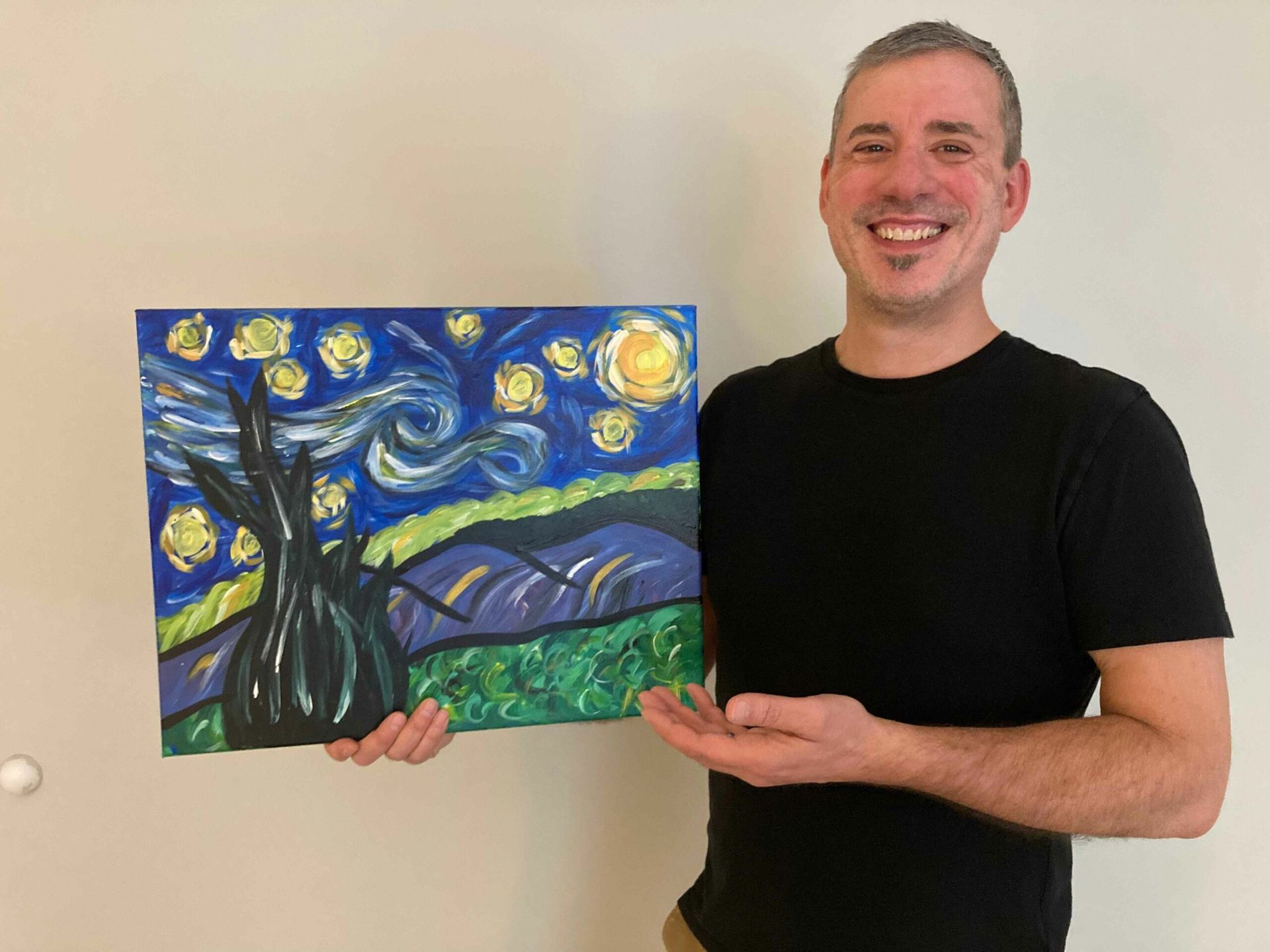 Man holding a painting of 
