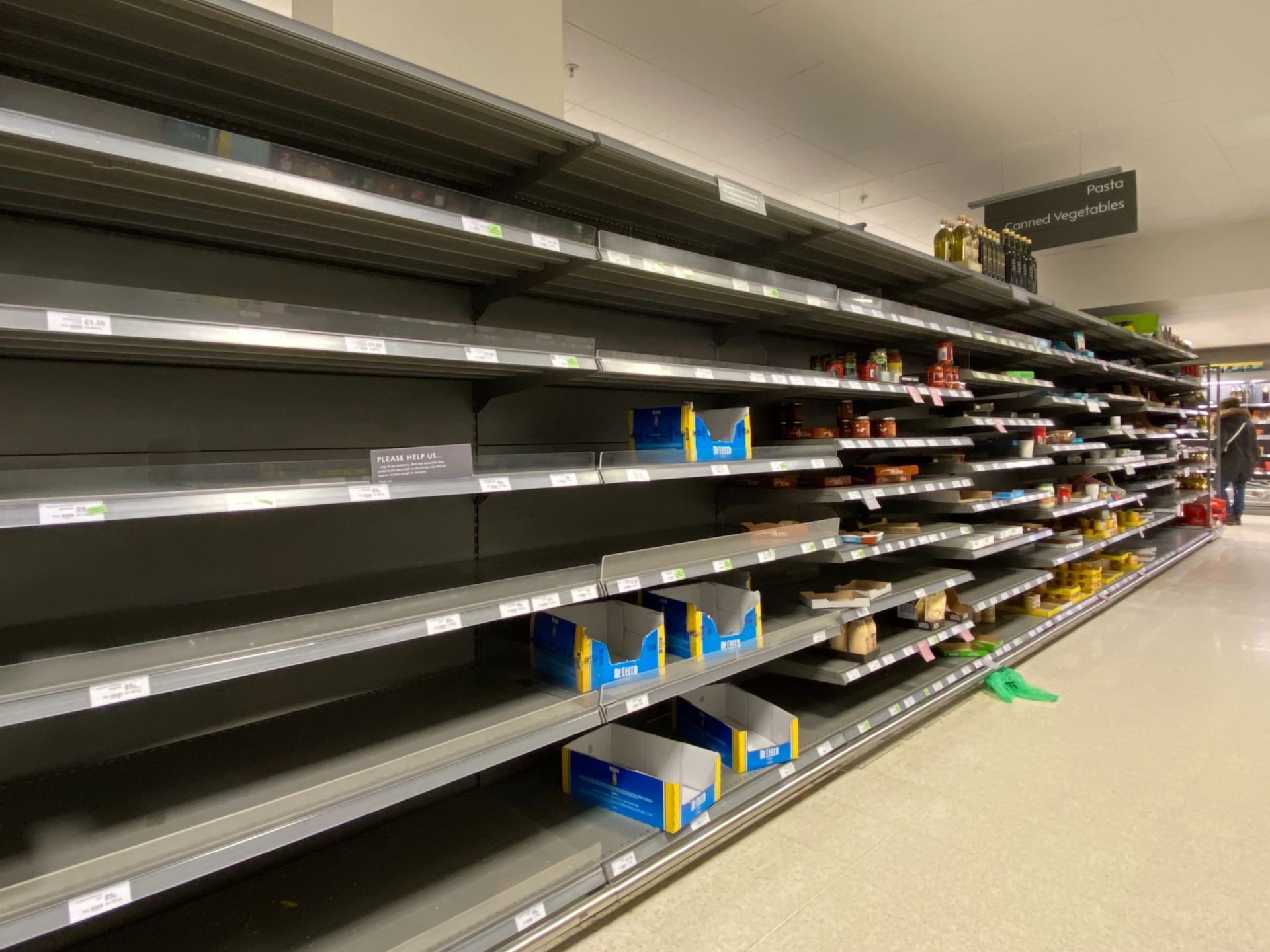 Empty grocery store shelves, likely due to product shortages.